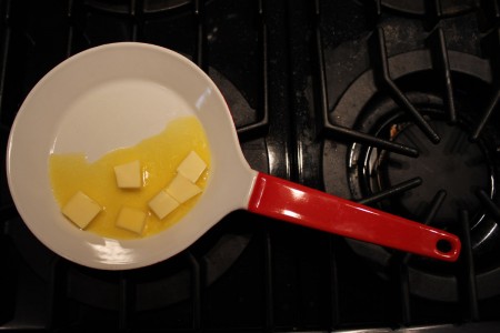 dutch cast iron enamel pan with melting butter